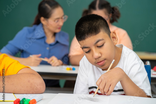 disability kid on wheelchair with Autism child in special classroom