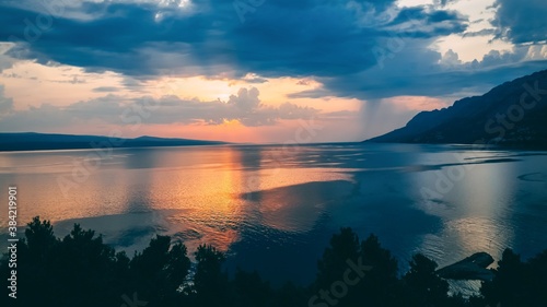 Beautiful sunset reflected in sea water. 16 on 9, Brela Croatia, Makarska riviera