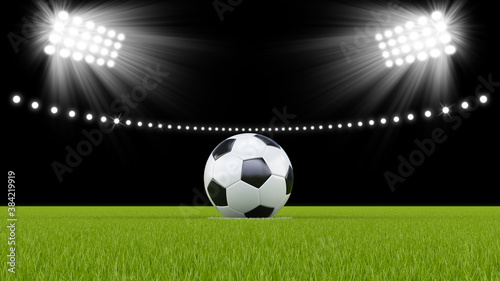 Soccer ball or football in the middle of the field with bright stadium lights © Mircea Maties