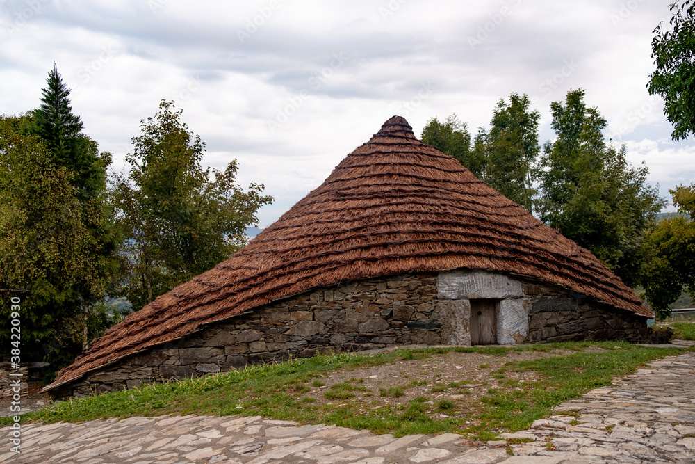 traditional house of O Cebreiro town known as Palloza, with thatched roof, made of stone bricks