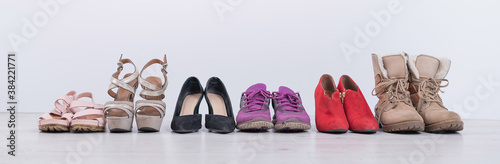 Women's choice of footwear for all seasons. Female shoes in a row on a white background © Михаил Решетников