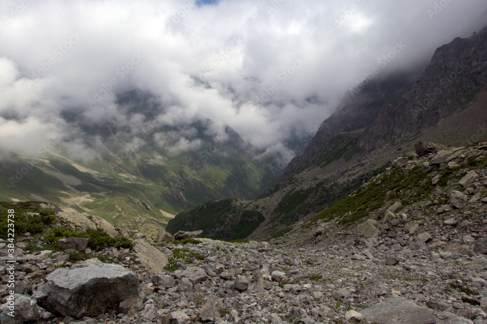 Alpine valley in the clouds. Kabardino-Balkarian natural reserve. Caucasus, Russia.