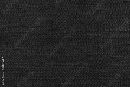 Black natural linen texture as a backdrop. Abstract cotton towel mockup template fabric on the background. Cloth wallpaper of artistic grey wale linen canvas texture for the painting. 