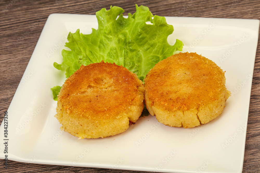 Vegan cuisine - Potato cutlet in the plate Vegan cuisine - Potato cutlet in the plate
