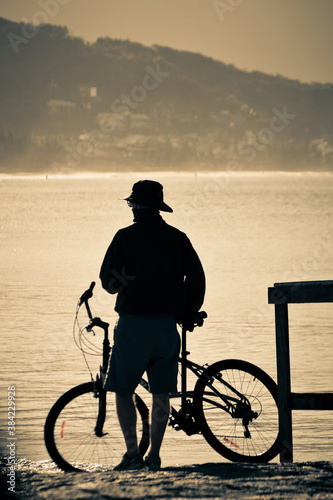 silhouette of a person riding a bike