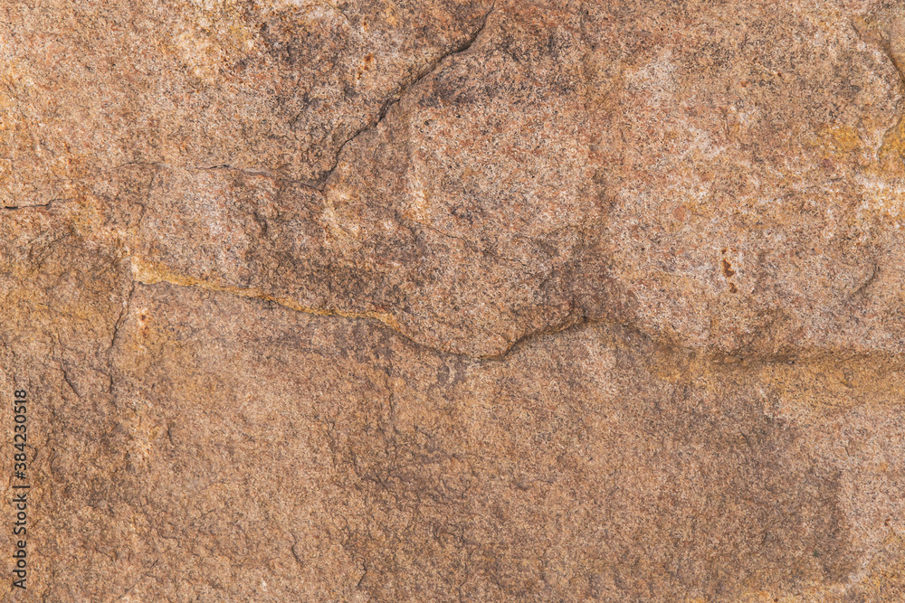 Textured brown stone rock surface close up Textured brown stone rock surface close up