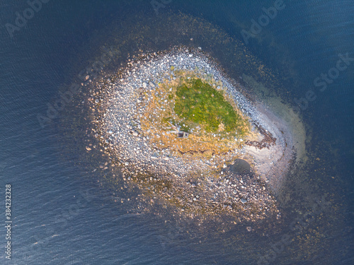 Boat crashed by a storm on a desert island photo