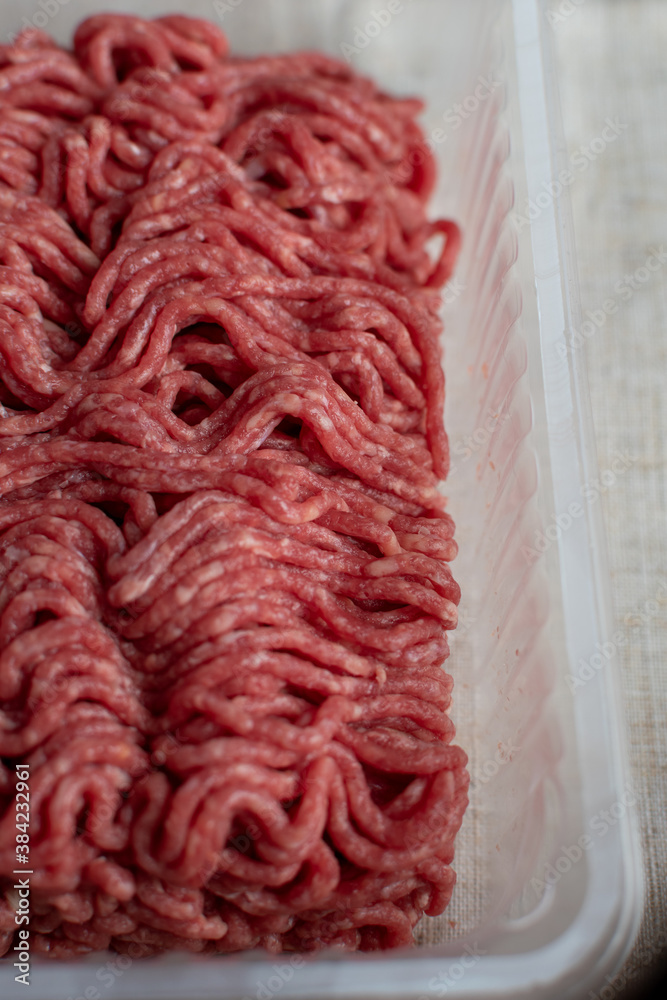 raw minced beef in plastic container raw minced beef in plastic container