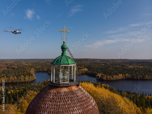 September, 2020 - Solovki. Helicopter and lighthouse. Sekirnaya mountain on the Solovetsky Islands. Russia, Arkhangelsk region photo