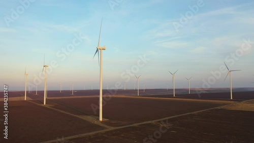 Eolian turbines park at sunet, warm light. Wind power concept