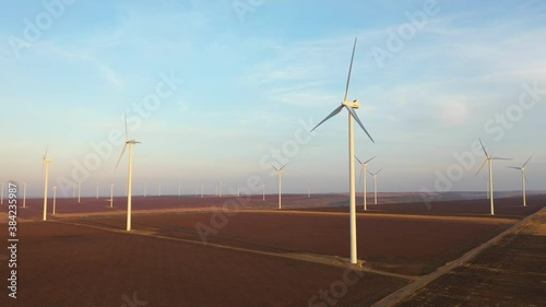 Eolian turbines park at sunet, warm light. Wind power concept