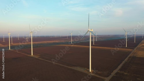 Eolian turbines park at sunet, warm light. Wind power concept