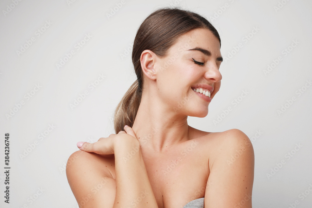 Portrait of young pretty woman with closed eyes, she is smiling and posing in the studio. Isolates on white wall. Portrait of young pretty woman with closed eyes, she is smiling and posing in the studio. Isolates on white wall.