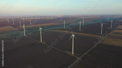 Eolian turbines park at sunet, warm light. Wind power concept