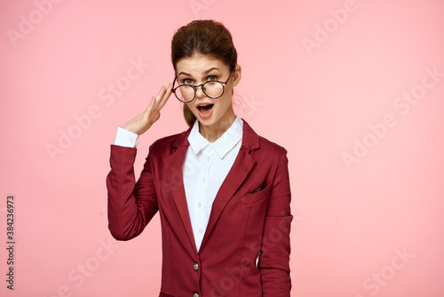 Business woman red jacket glasses executive lifestyle studio pink background