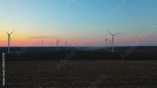 Eolian turbines park at sunet, warm light. Wind power concept