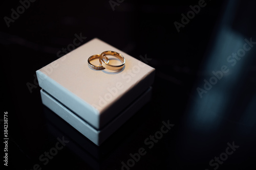 Diamond gold wedding rings on a white box © sergiokat