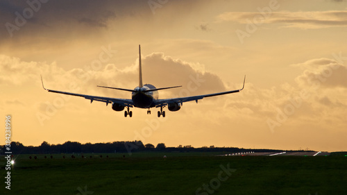 Airplane Landing on a runway at dusk