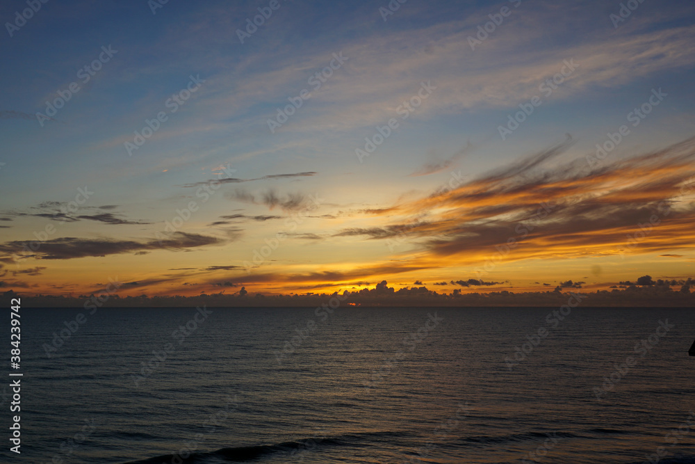 A blue, yellow, and orange sunrise over the Atlantic Ocean A blue, yellow, and orange sunrise over the Atlantic Ocean