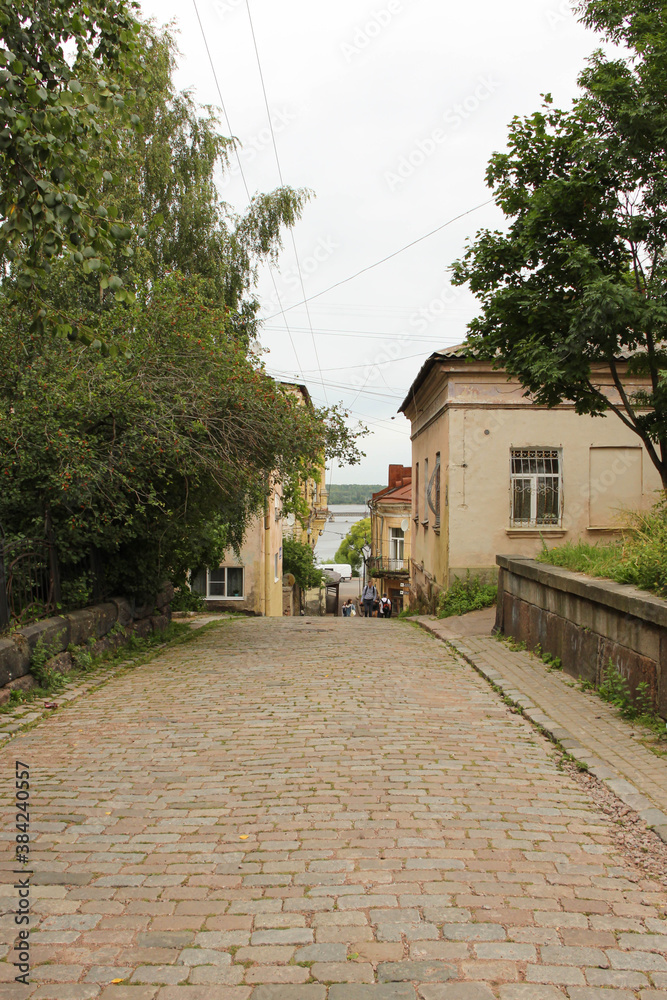street in the old city. The road from the ancient paving stone, leading down and a small bright house.