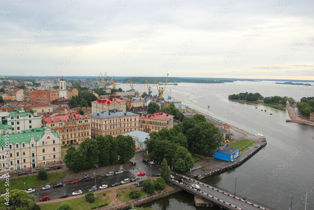Obraz premium Top view of the beautiful old town, water and cozy colored houses, Russia, Vyborg.