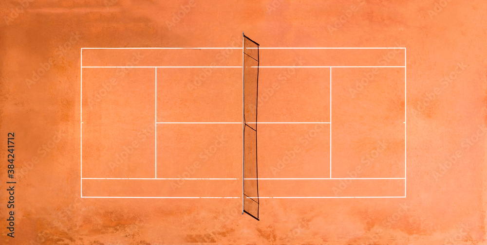 View from above, aerial view of an empty clay court. A clay court is a tennis court that has a playing surface made of crushed stone, brick, shale, or other unbound mineral aggregate.