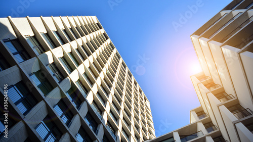 Apartment residential house and home facade architecture and outdoor facilities. Blue sky on the background. Sunlight