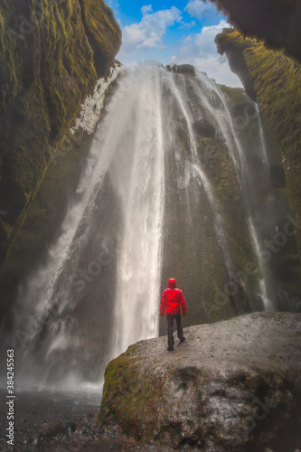 Tourist looking up at waterfall  Selfoss  Arnessysla  Iceland
