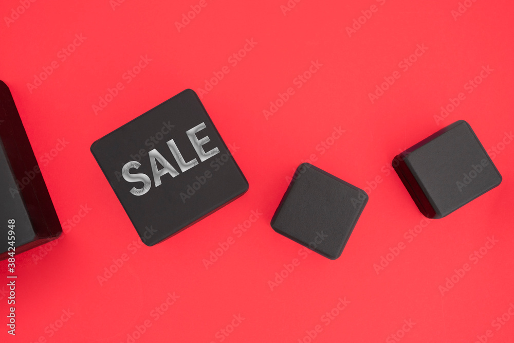 Black boxe with Sale word on red background for Shopping and discount concept.Top view. Black boxe with Sale word on red background for Shopping and discount concept.Top view.