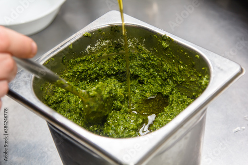 Recipe for pesto sauce. Add olive oil to the Basil leaves and whisk in a blender.