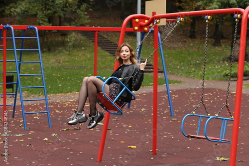 woman riding a swing in the park