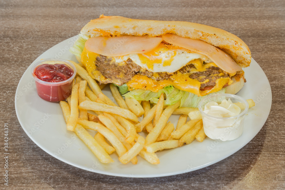 Ham, egg and beef sandwich with fries