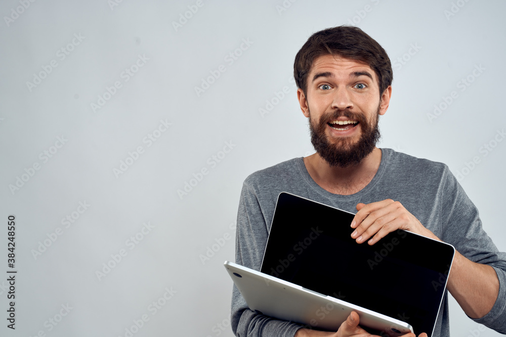 man holding laptop technology internet work communication light background man holding laptop technology internet work communication light background
