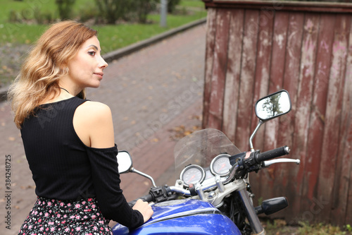 Pretty woman sitting on the motorcycle