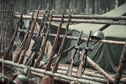 Rifles  machine guns and submachine guns in a military camp in the forest