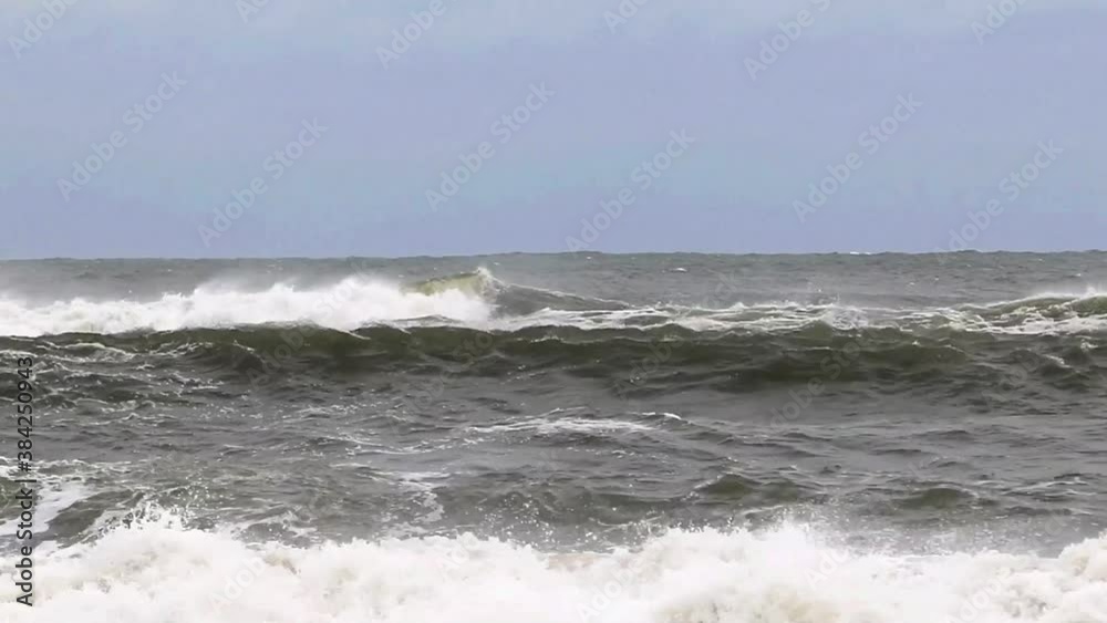 Atlantic Ocean with large waves one after the other from a storm off of the coast of Long Island and a strong wind blowing the spray backwards. Atlantic Ocean with large waves one after the other from a storm off of the coast of Long Island and a strong wind blowing the spray backwards.