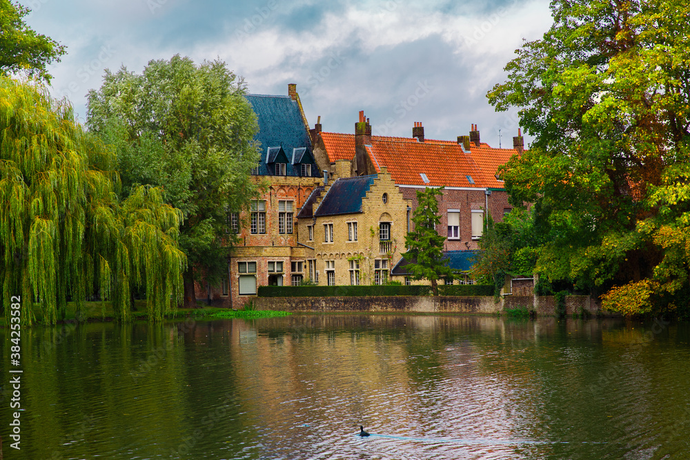 Bruges, Flanders, Belgium, Europe - October 1, 2019. Neo-Gothic medieval castle on the shore of lake of love in autumn Bruges (Brugge)