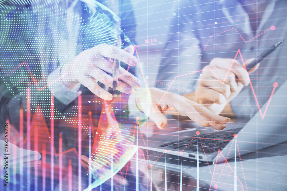 Multi exposure of man and woman working together and financial chart hologram. Business concept. Computer background. Multi exposure of man and woman working together and financial chart hologram. Business concept. Computer background.