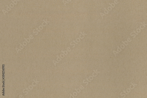 Close up of a light brown vintage rough sheet of carton. Cardboard paper texture with a blank background. Empty papercraft surface. Recycled environmentally friendly material.