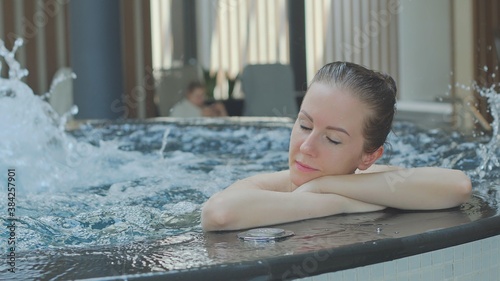 Woman relaxing in hot tube, Resting in whirlpool water in wellness spa resort. 