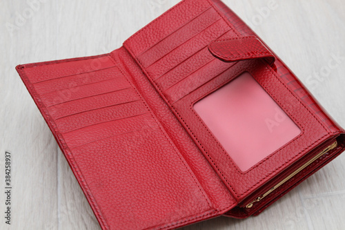 open empty red women wallet on gray background