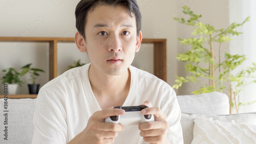 リビングでテレビゲームをする男性