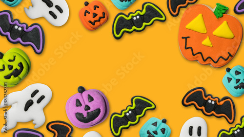 Halloween concept pumpkin Jack-o-lantern, bat, ghost. Fun dessert cookie and candy. Trick or treat Happy Halloween. Flat lay, top view. Copy space. Photo good for greeting card, billboard, poster. 