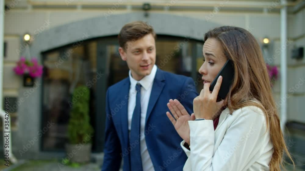 Side view couple talking to client at street. Man showing thumbs up outdoor