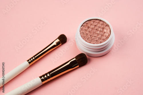 eyeshadow makeup brushes collection professional cosmetics accessories on pink background