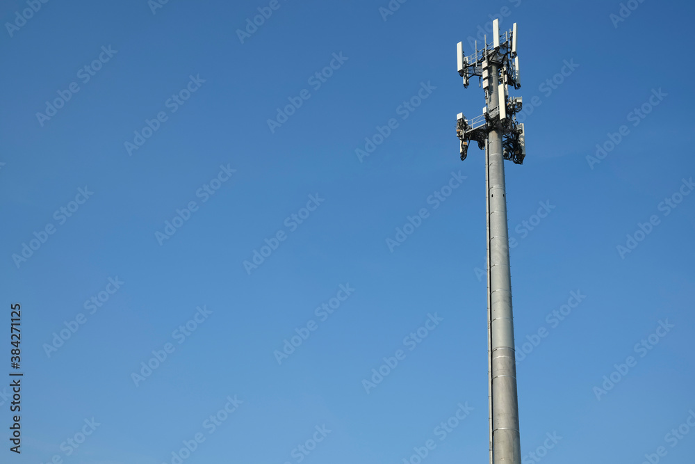 Mobile phone tower against blue sky