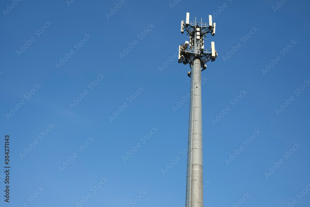 Mobile phone tower against blue sky