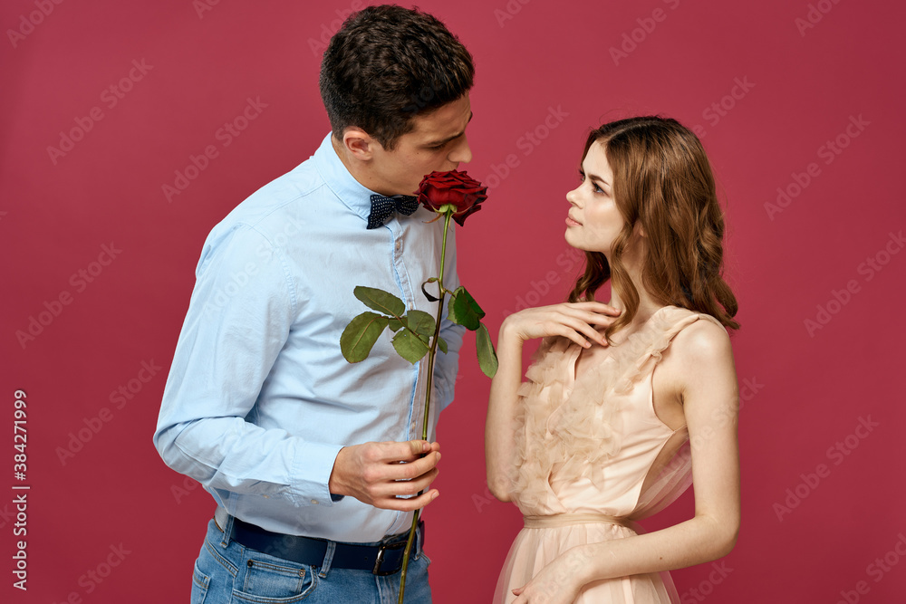 Lovers people with rose in hands on pink isolated background hug emotions happiness romance feelings Lovers people with rose in hands on pink isolated background hug emotions happiness romance feelings