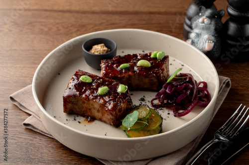 Tofu steak, marinated in teriyaki sauce and served with edamame beans, gourmet meal in a fancy restaurant, top view