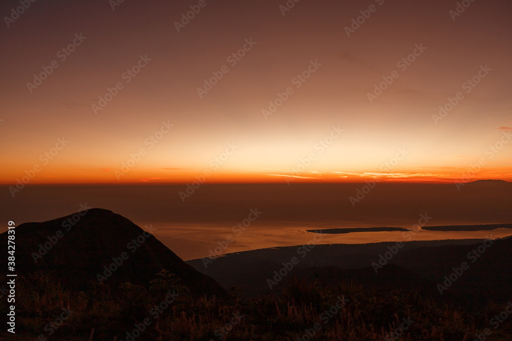 Beautiful view sunrise and foggy landscape from top of mountain in the morning at Rinjani National Park, Lombok, Indonesia